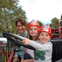 Two children in plastic fire helmets