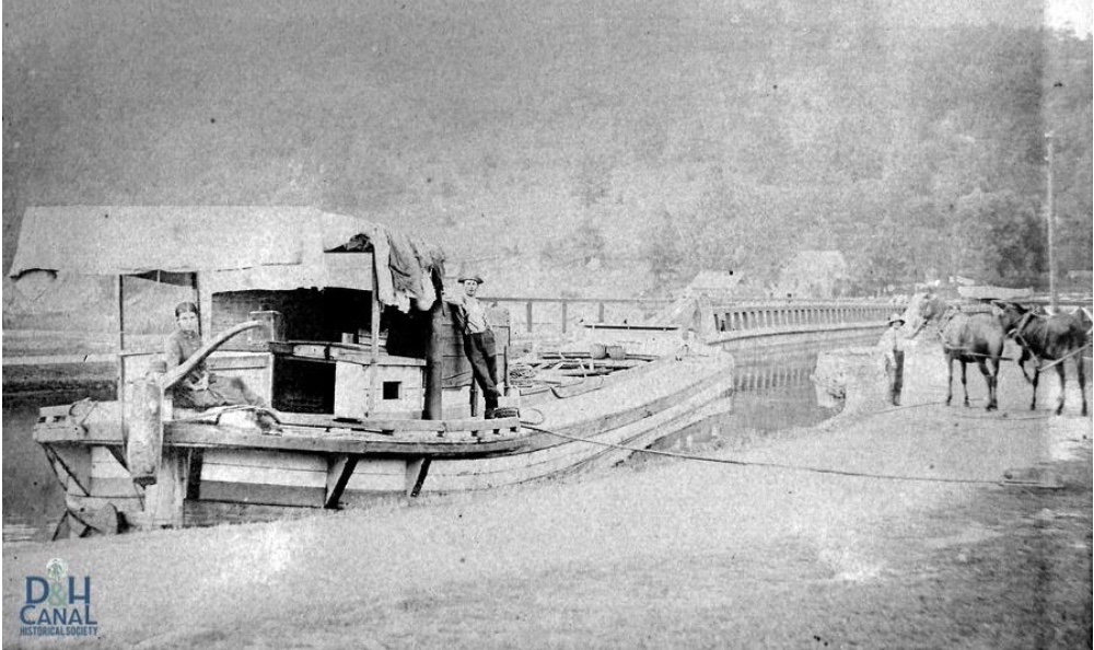 Florence, Philip, and Ralph DeGroodt and their D&H Canal boat waiting to enter a Roebling aqueduct c1895.